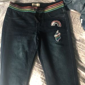 Dark blue jeans with colorful patches.